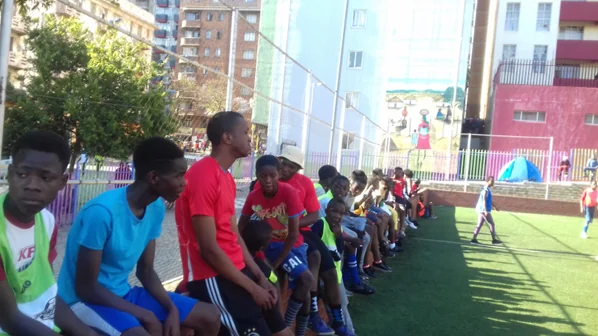 Coach talking to young players during a break